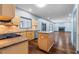 Bright kitchen with stainless steel appliances, a center island, and a view into the living room with a fireplace at 1021 Adah Ln, Lawrenceville, GA 30043