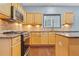 Bright kitchen featuring stainless steel appliances, tile backsplash, and hardwood flooring at 1021 Adah Ln, Lawrenceville, GA 30043