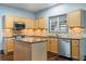Well-lit kitchen featuring wooden cabinets, stainless steel appliances, and granite countertops at 1021 Adah Ln, Lawrenceville, GA 30043
