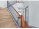 Carpeted staircase with decorative iron railing and hardwood flooring at 1021 Adah Ln, Lawrenceville, GA 30043