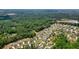 Aerial view of a cozy neighborhood with homes bordering a lush forest, blending community living with a nature-filled backdrop at 2861 Digna Ct, Acworth, GA 30101