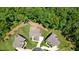 A high-angle aerial view displaying the layout of the property, including its surrounding landscaping and proximity to lush forest at 2861 Digna Ct, Acworth, GA 30101