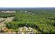 Aerial view showcasing the property's location within a lush, wooded neighborhood near the local school at 2861 Digna Ct, Acworth, GA 30101