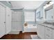 Bright bathroom has double sinks, white cabinetry, soaking tub, and a separate shower at 3624 Bancroft Main Nw, Kennesaw, GA 30144