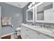 Bathroom with marble countertop, dual sinks, modern faucets, and white cabinetry at 3624 Bancroft Main Nw, Kennesaw, GA 30144