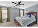 Bedroom featuring neutral carpet, a ceiling fan, and a wooden headboard bed at 3624 Bancroft Main Nw, Kennesaw, GA 30144