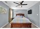 Bedroom featuring neutral carpet, a ceiling fan, and a wooden headboard bed at 3624 Bancroft Main Nw, Kennesaw, GA 30144