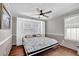 Bedroom featuring hardwood floors, a ceiling fan, and a queen bed at 3624 Bancroft Main Nw, Kennesaw, GA 30144