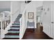 Bright foyer with hardwood floors and a staircase with patterned risers at 3624 Bancroft Main Nw, Kennesaw, GA 30144