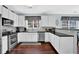 Modern kitchen with stainless steel appliances and dark granite countertops at 3624 Bancroft Main Nw, Kennesaw, GA 30144