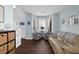 Living room area with hardwood floors and bright lighting from large windows at 3624 Bancroft Main Nw, Kennesaw, GA 30144
