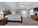 Main bedroom suite features a tray ceiling, a ceiling fan, and an ensuite bathroom at 3624 Bancroft Main Nw, Kennesaw, GA 30144