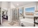 Bright bathroom featuring glass shower, large soaking tub and tile floors, providing a spa-like experience at 202 Woodstone Ct, Atlanta, GA 30331