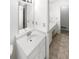 A well-lit bathroom featuring a vanity sink, a large mirror, and a doorway to the toilet at 4726 Alpine Sw Dr, Lilburn, GA 30047