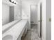 A bathroom with a double vanity and a long mirror, with a spacious layout at 4726 Alpine Sw Dr, Lilburn, GA 30047