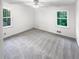 Bright bedroom featuring two windows offering outdoor views and natural light at 4726 Alpine Sw Dr, Lilburn, GA 30047