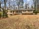 Charming ranch-style home with a cozy front porch and mature trees, providing curb appeal at 4726 Alpine Sw Dr, Lilburn, GA 30047