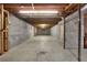 Expansive unfinished basement area with concrete flooring, exposed ceiling, and block walls at 103 Timberlane Rd, Cumming, GA 30040