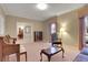 Cozy living room with large windows, piano, and neutral tones, open to dining room at 103 Timberlane Rd, Cumming, GA 30040