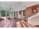 Charming sunroom with brick accent wall, mosaic tile floor and multiple windows offering natural light at 103 Timberlane Rd, Cumming, GA 30040