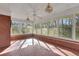 Bright sunroom with a mosaic tile floor surrounded by windows overlooking outdoor scenery at 103 Timberlane Rd, Cumming, GA 30040