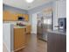 Functional kitchen featuring stainless steel appliances, wood cabinets, and view of the flooring at 151 Creekwood Dr, Woodstock, GA 30188