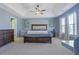 Spacious main bedroom with a tray ceiling, fan, a queen bed, and ample natural light at 151 Creekwood Dr, Woodstock, GA 30188