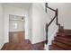 Bright foyer with hardwood floors, staircase, and a view into a living room with ceiling fan at 3240 Arbor Oaks Dr, Snellville, GA 30039