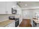 Kitchen featuring stainless steel appliances, granite countertops, white cabinets, and hardwood floors at 3240 Arbor Oaks Dr, Snellville, GA 30039