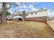 Spacious backyard featuring a screened porch, partial brick exterior, and a well-kept fence at 3284 Devaughn Ne Dr, Marietta, GA 30066