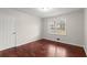 This bedroom features pristine walls, hardwood floors, and a window to let natural light in at 3284 Devaughn Ne Dr, Marietta, GA 30066