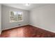 This bedroom features pristine walls, hardwood floors, and a window to let natural light in at 3284 Devaughn Ne Dr, Marietta, GA 30066