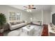 Bright living room with a large window, neutral furniture, and a ceiling fan at 3284 Devaughn Ne Dr, Marietta, GA 30066