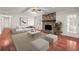 Inviting living room with a stone fireplace, hardwood floors, and plenty of seating at 3284 Devaughn Ne Dr, Marietta, GA 30066