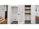 Hallway with steps, storage shelves and a door at 466 Thackery Sw Pl, Atlanta, GA 30311