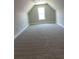 Spacious upper-level carpeted bedroom features a bright window at 200 Brookwood Xing, Douglasville, GA 30134