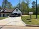 Long concrete driveway of a modern, newly built home with green lawn, under a sunny sky at 200 Brookwood Xing, Douglasville, GA 30134