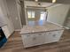 Granite kitchen island in modern kitchen with recessed lighting and views to the living area at 200 Brookwood Xing, Douglasville, GA 30134