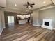Bright open-concept living room featuring hardwood floors, modern fireplace, and kitchen with island at 200 Brookwood Xing, Douglasville, GA 30134
