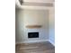 Modern living room with hardwood floors, a sleek fireplace, and a wooden shelf at 200 Brookwood Xing, Douglasville, GA 30134