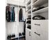 Organized walk-in closet featuring built-in shelving, drawers, and hanging racks for clothing storage at 2008 Cottonwood Ln, Woodstock, GA 30188