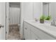 Bright bathroom with a double vanity, sleek fixtures, and a linen closet providing ample storage and functionality at 242 Crestbrook Ln, Dallas, GA 30157