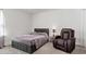 Stylish bedroom with a cozy armchair, comfortable bed, and contemporary decor creating a relaxing retreat at 242 Crestbrook Ln, Dallas, GA 30157