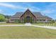 Stately clubhouse featuring a stone facade, covered entry, and mature landscaping at 242 Crestbrook Ln, Dallas, GA 30157