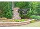 Stone community sign surrounded by lush landscaping and colorful flowers at 242 Crestbrook Ln, Dallas, GA 30157