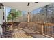 View of the outdoor deck featuring wood flooring and a charming railing overlooking a serene wooded landscape at 242 Crestbrook Ln, Dallas, GA 30157