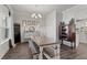Bright dining room featuring a wooden table, bench, and chandelier at 242 Crestbrook Ln, Dallas, GA 30157