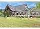 Beautiful home exterior with manicured lawn, stone accents, and charming shutters at 242 Crestbrook Ln, Dallas, GA 30157
