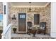 Inviting front porch with rocking chairs and classic brickwork at 242 Crestbrook Ln, Dallas, GA 30157