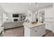 Open-concept kitchen with granite island and stainless appliances, leading into cozy living area at 242 Crestbrook Ln, Dallas, GA 30157